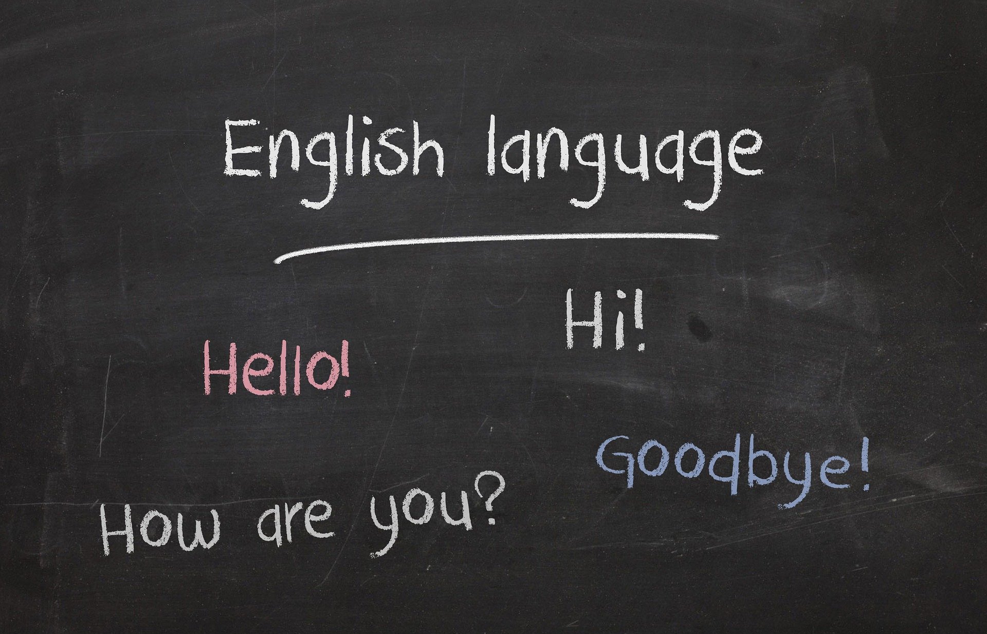 Chalkboard that says, ‘English language,’ ‘Hello!’ ‘Hi!’ ‘How are you?’ and ‘Goodbye!